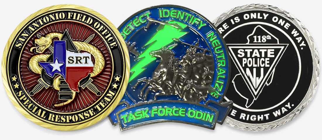 Examples of coins with translucent, glow-in-the-dark, and matte black enamels