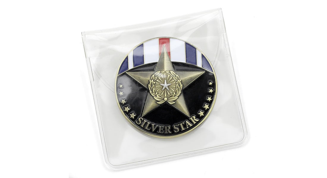 A challenge coin packed up in a clear PVC pouch