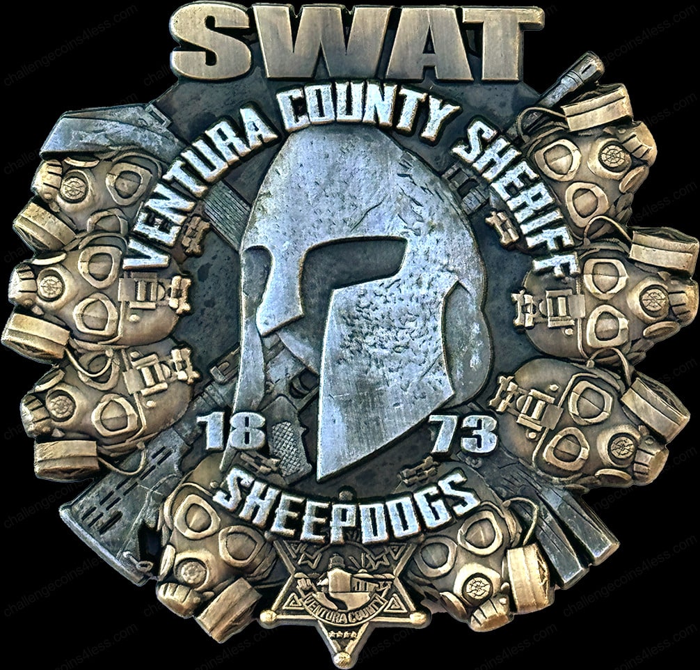 challenge coin for the Ventura County Sheriff SWAT team. The coin features a central Spartan helmet design surrounded by an array of tactical gear and weapons. 'SHEEPDOGS' and the founding year '1873' are prominently displayed at the bottom, celebrating the unit's legacy and commitment.