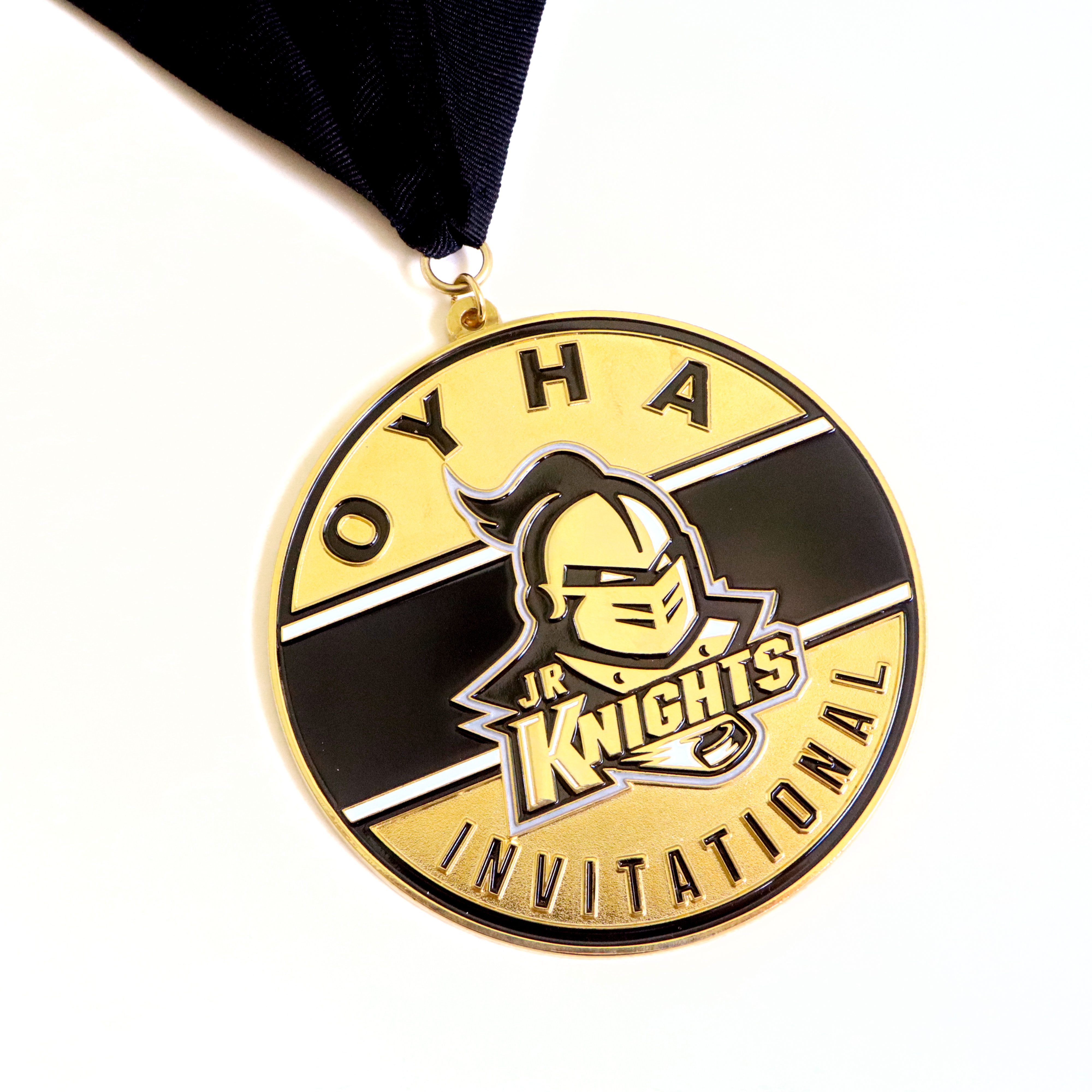 Gold OYHA Jr. Knights Invitational hockey medal with knight mascot logo and black enamel on dark navy ribbon